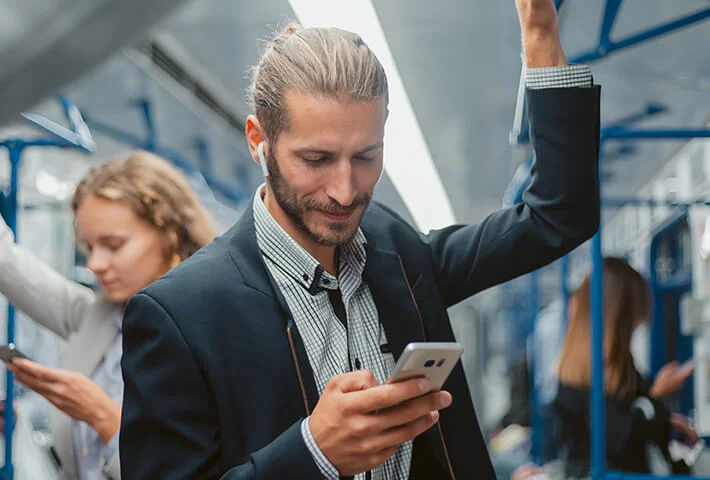 man in metro using phone